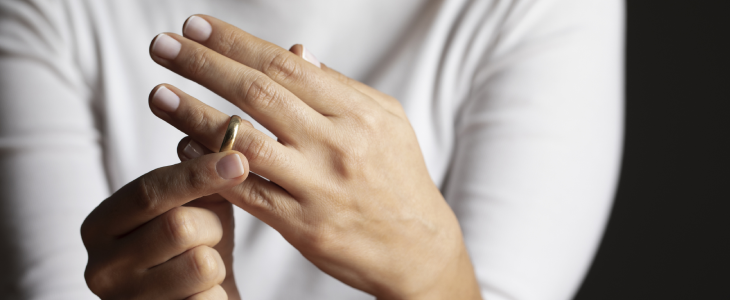 Woman taking her ring off after a legal separation.