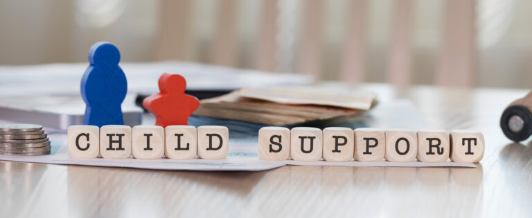 Word CHILD SUPPORT composed of wooden letters. Closeup